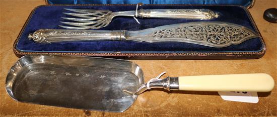 A cased pair of Victorian plated fish servers and an ivory handled silver plated crumb scoop.